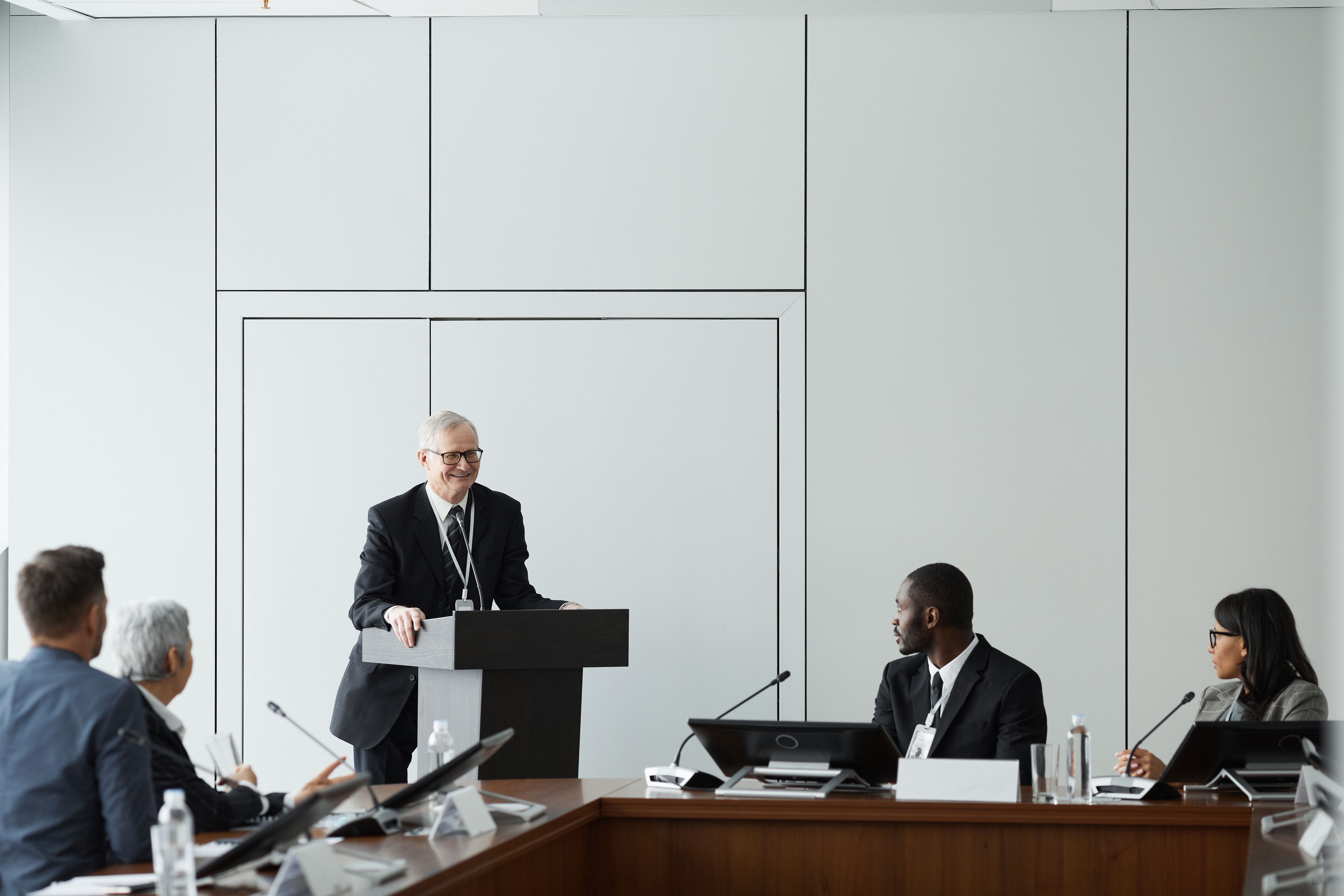 Federal agency officials in a formal conference meeting presentation